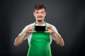 Portrait supermarket employer holding smartphone and smiling