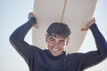 Portrait, surf and man surfer with surfboard at the beach, sea or ocean with a smile and is happy on a summer day Royalty Free Stock Photo