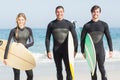 Portrait of surfer friends with surfboard standing on the beach Royalty Free Stock Photo