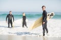 Portrait of surfer friends with surfboard standing on the beach Royalty Free Stock Photo