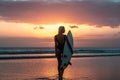 Portrait of surfer girl with beautiful body on the beach with surfboard at colourful sunset time Royalty Free Stock Photo