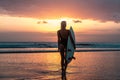 Portrait of surfer girl with beautiful body on the beach with surfboard at colourful sunset time Royalty Free Stock Photo