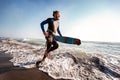 Surfer man with surf board on the beach. Summer sport activity