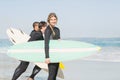 Portrait of surfer woman with surfboard standing on the beach Royalty Free Stock Photo