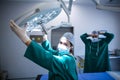 Portrait of surgeon adjusting surgical light in operation room