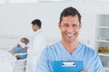 Portrait of surgeon with doctor attending patient on background Royalty Free Stock Photo