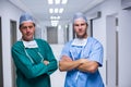 Portrait of surgeon and nurse standing in corridor Royalty Free Stock Photo