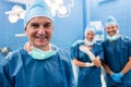 Portrait of surgeon and nurses smiling in operation room Royalty Free Stock Photo