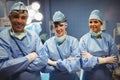 Portrait of surgeon and nurses standing with arms crossed in operation room Royalty Free Stock Photo