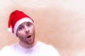 Portrait of a surprise man in a santa claus hat on a white background. New Year 2021. Copy space Royalty Free Stock Photo