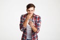 Portrait of a surprised casual man looking at mobile phone Royalty Free Stock Photo