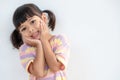 Portrait of surprised cute little toddler girl child standing isolated over white background. looking at the camera. hands near Royalty Free Stock Photo