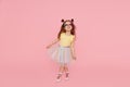 Portrait of surprised cute little toddler girl  in sunglasses over pink background. Royalty Free Stock Photo