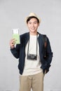 Portrait of surprised excited asian man holding passport and boarding pass ticket Royalty Free Stock Photo