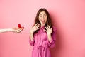 Portrait of surprised girlfriend scream of excitement as hand showing her engagement ring, recieve marriage proposal Royalty Free Stock Photo