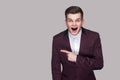 Portrait of surprised handsome young man in violet suit and whit Royalty Free Stock Photo
