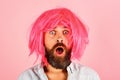 Portrait of surprised man with beard and mustache in colorful wig. Emotions. Party time. Fashion concept. Stylish