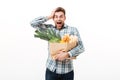 Portrait of a surprised man holding paper bag Royalty Free Stock Photo