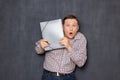 Portrait of surprised shocked man looking from behind folder Royalty Free Stock Photo