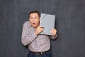 Portrait of surprised shocked man looking from behind folder Royalty Free Stock Photo