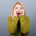 Portrait of a surprised woman against gray background Royalty Free Stock Photo