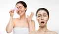 Portrait of a surprised woman with big wrinkles on her face and dry skin, and a beautiful smiling woman with a gua sha Royalty Free Stock Photo