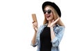 Portrait of surprised young woman with phone on city street wearing a black round hat isolated on white background Royalty Free Stock Photo