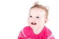 Portrait of a sweet baby girl with curly hair and blue eyes wearing a pink sweater with hearts pattern Royalty Free Stock Photo