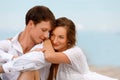 Portrait of a sweet couple of young lovers resting on the beach Royalty Free Stock Photo