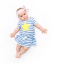 Portrait of a sweet infant baby girl wearing a pink dress and headband bow, isolated on white in studio Royalty Free Stock Photo