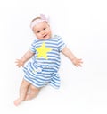 Portrait of a sweet infant baby girl wearing a pink dress and headband bow, isolated on white in studio Royalty Free Stock Photo