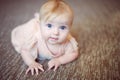 Portrait of a sweet infant baby girl wearing a pink dress in studio