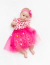 Portrait of a sweet infant wearing a pink tutu and headband bow, isolated on white Royalty Free Stock Photo