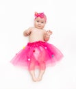 Portrait of a sweet infant wearing a pink tutu and headband bow, isolated on white Royalty Free Stock Photo