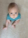 Portrait of a sweet little baby boy looking up with beautiful and innocent eyes