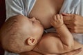 Little baby holding to his mother while breastfeeding Royalty Free Stock Photo