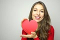 Portrait of a sweet perfect girl smiling at camera with heart shaped paper in her hands. Valentine`s Day concept. Royalty Free Stock Photo