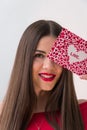 Portrait of a sweet perfect girl smiling at camera with heart shaped paper in her hands. Valentine`s Day or Women`s Day Royalty Free Stock Photo