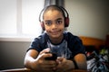 A Portrait of a sweet young boy listening to music on headphones Royalty Free Stock Photo