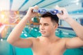 Portrait swimmer happy young man, background swimming pool blue water Royalty Free Stock Photo