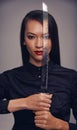 Portrait, sword and warrior with an asian woman in studio on a gray background for martial arts or combat. Training