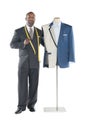 Portrait of tailor standing with mannequin Royalty Free Stock Photo