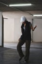 Portrait of talented woman performing various freestyle dance in parking garage