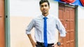 A portrait of a tall young Asian business man wearing a white shirt, blue necktie and hand watch Royalty Free Stock Photo