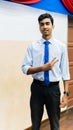 A portrait of a tall young Asian business man wearing a white shirt, blue necktie and hand watch Royalty Free Stock Photo