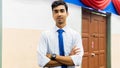 A portrait of a tall young Asian business man wearing a white shirt, blue necktie and hand watch Royalty Free Stock Photo