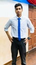 A portrait of a tall young Asian business man wearing a white shirt, blue necktie and hand watch Royalty Free Stock Photo