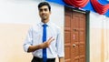 A portrait of a tall young Asian business man wearing a white shirt, blue necktie and hand watch Royalty Free Stock Photo