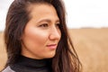 Portrait tanned girl of European appearance. Girl in the field looking into the distance