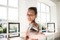 Portrait of tanned healthy woman doing fitness exercises in sunny gym